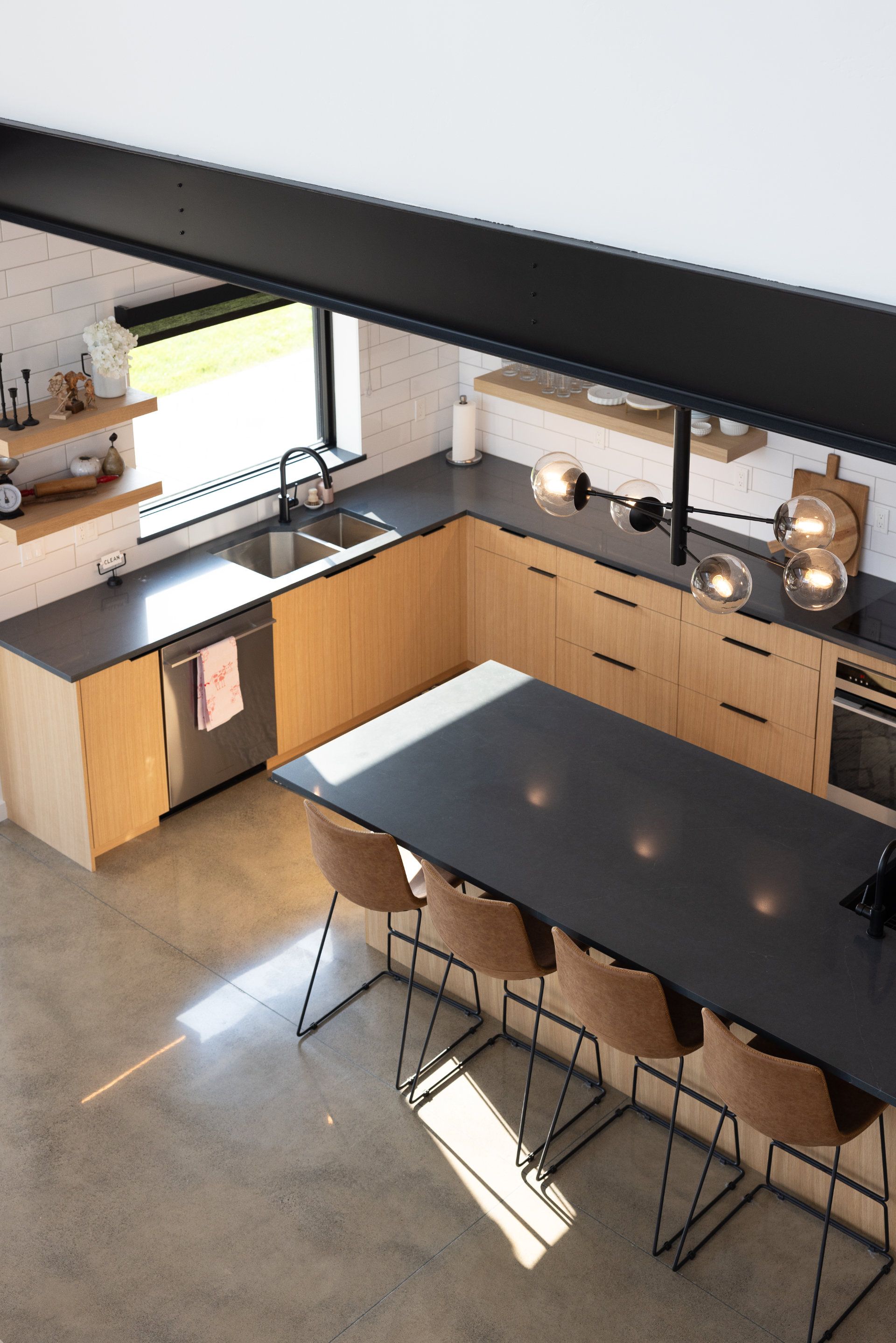 An aerial view of a kitchen with a table and chairs