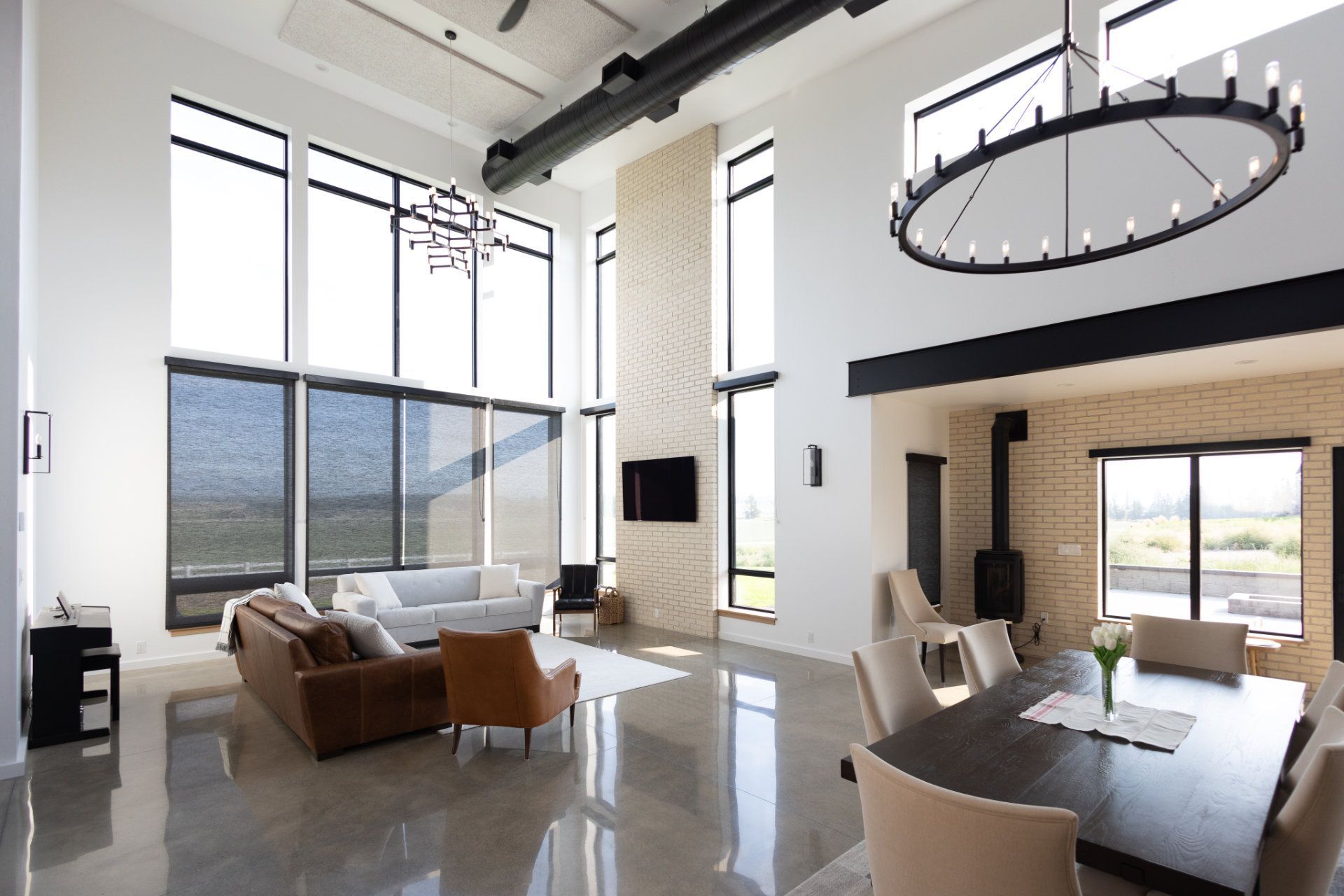 A living room with a couch and chairs and a dining table