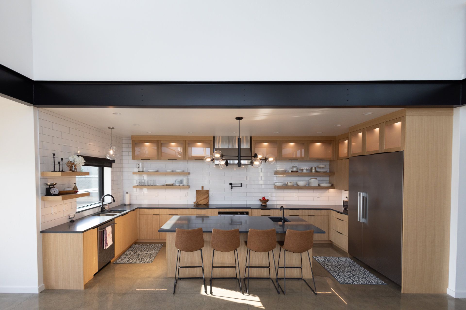 A kitchen with stainless steel appliances , wooden cabinets , and a large island.