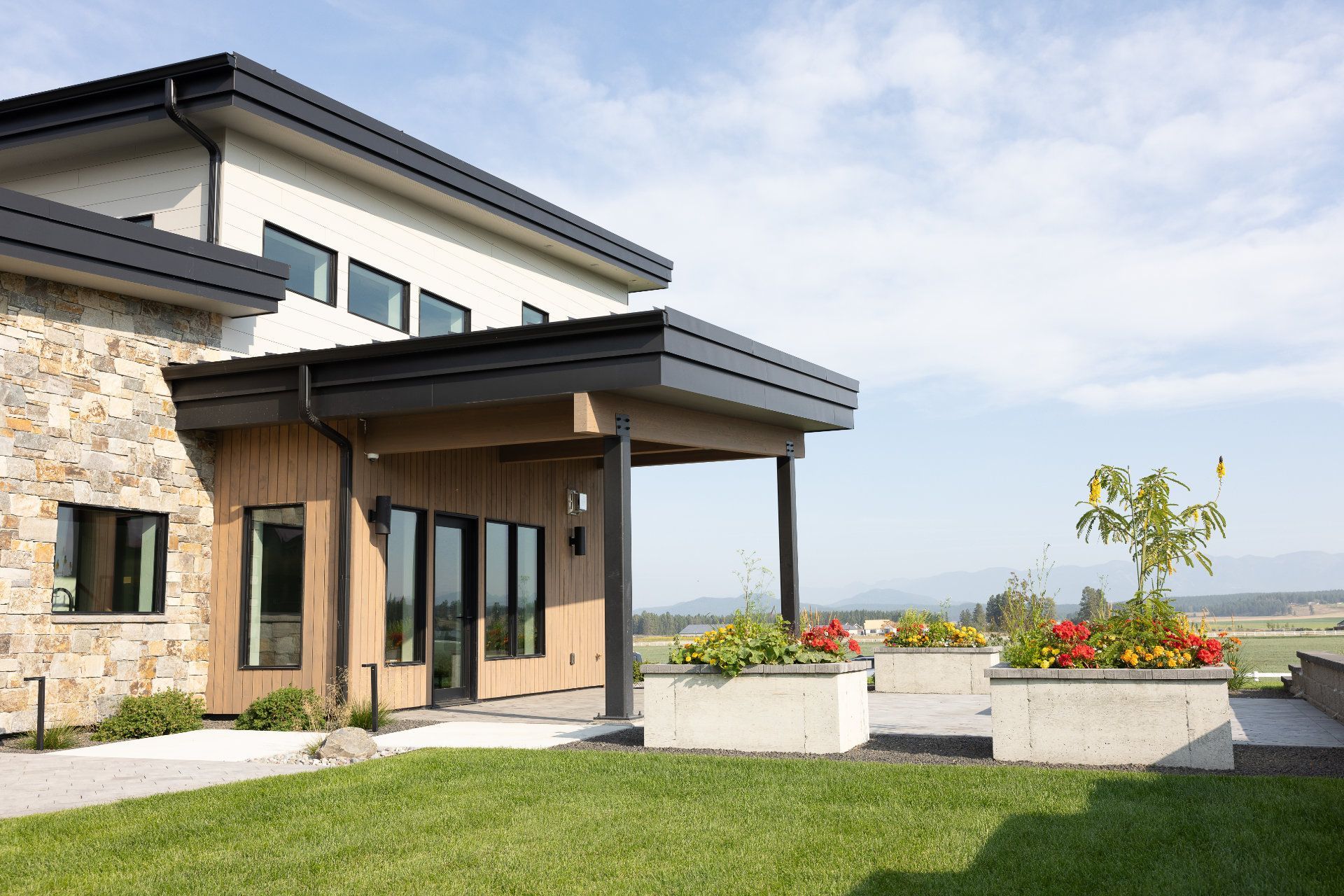 A large house with a lush green lawn in front of it