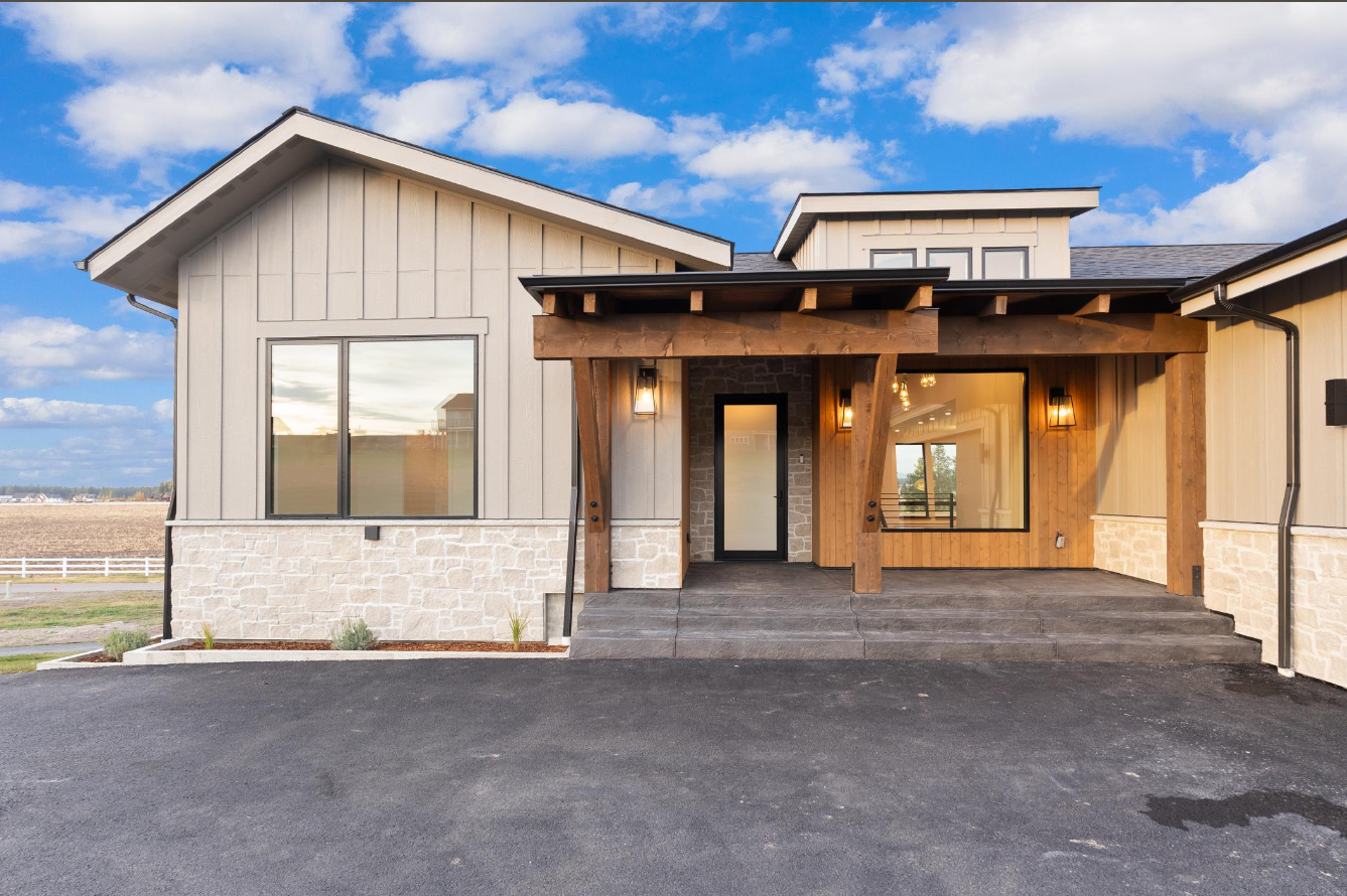 The front of a house with a porch and a lot of windows.
