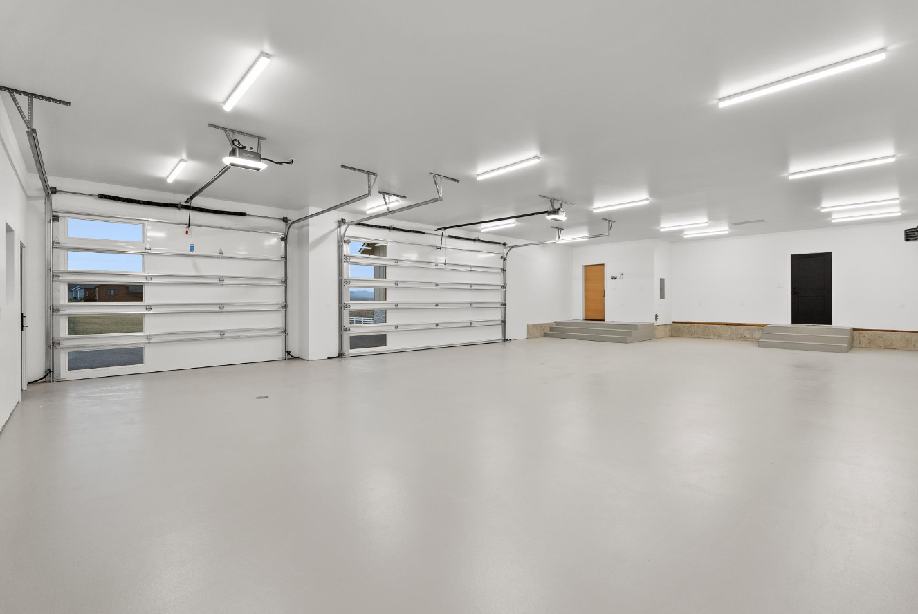 A large empty garage with a lot of lights on the ceiling.