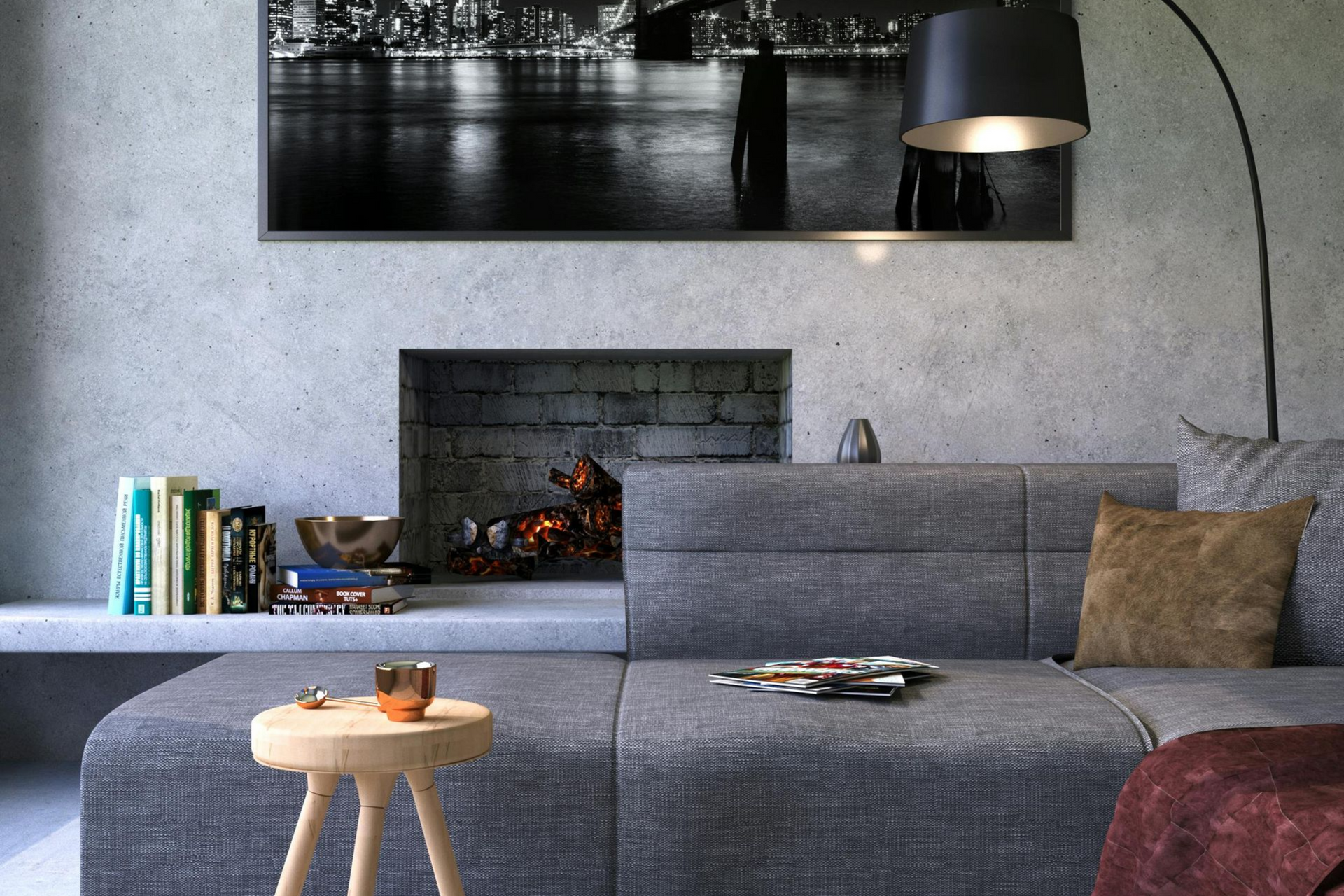 Cozy living room with a gray sectional, fireplace with burning logs, and a large black and white cityscape photo.