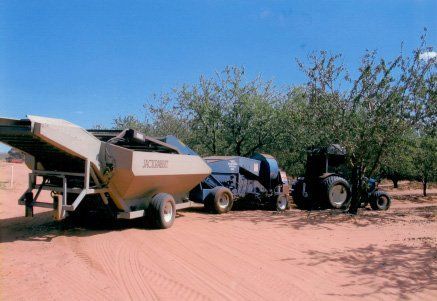 Tractor spray fertilise field with insecticide herbicide chemicals in agriculture field