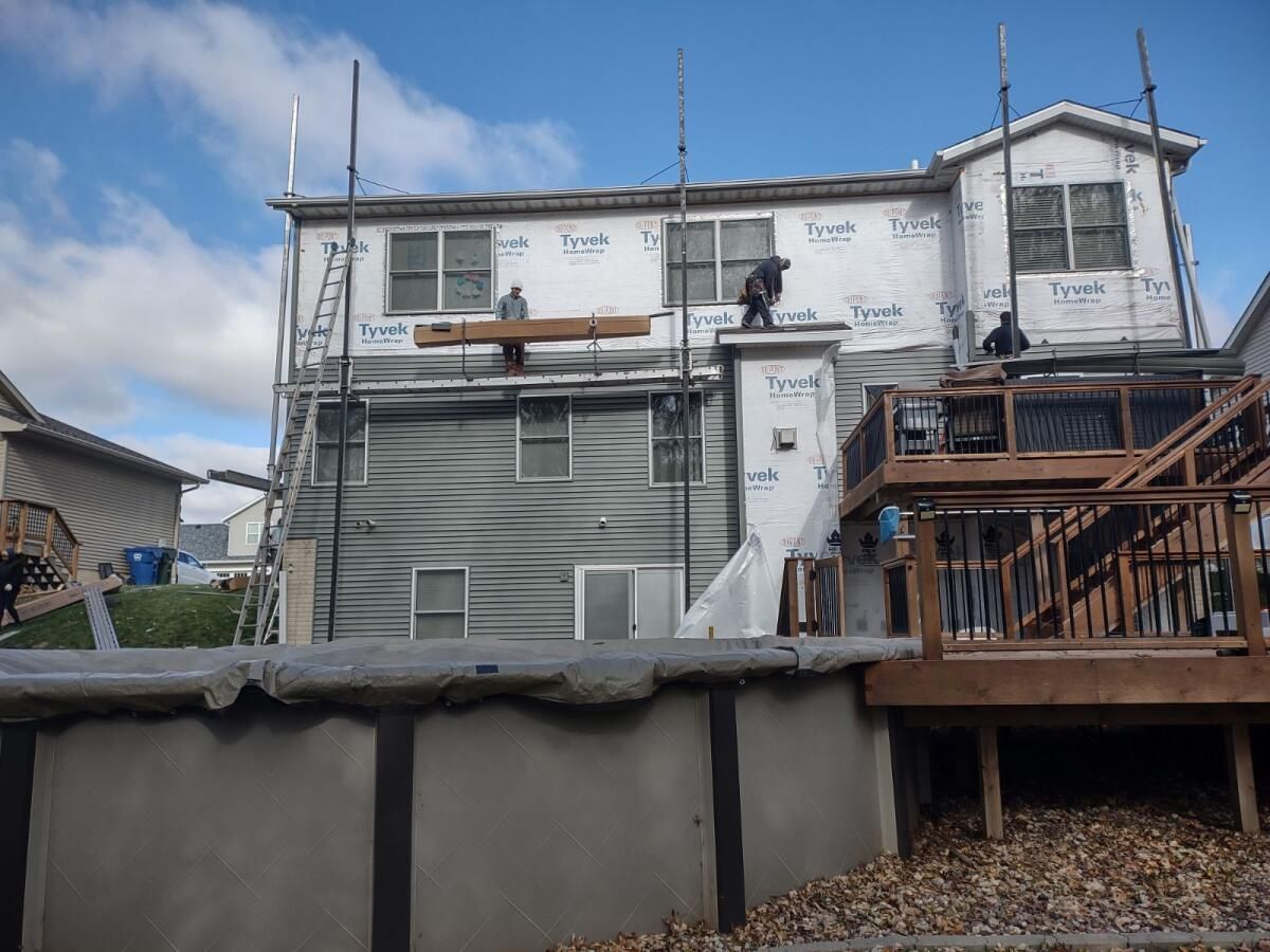 A house is being remodeled with scaffolding and a deck.