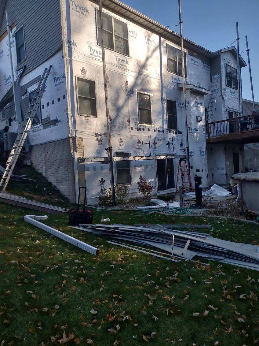 A large white building with a lot of windows is being remodeled.
