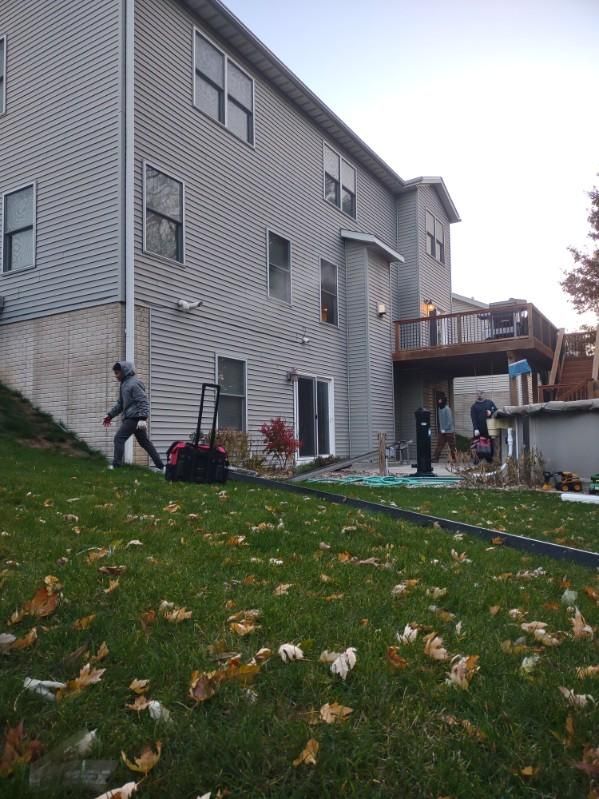 A man is standing in front of a large house.