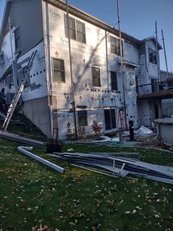 A large house with a lot of windows is being remodeled.
