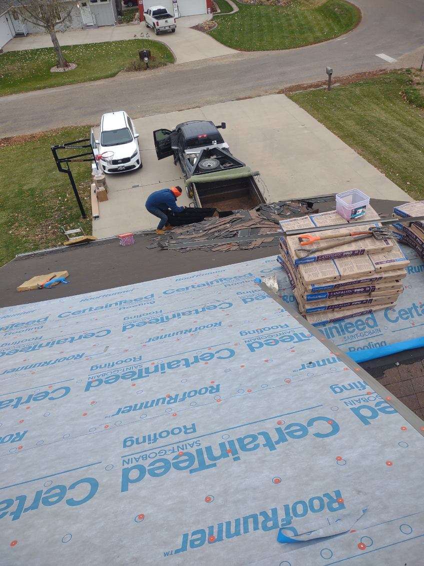 An aerial view of a roof being installed on a house.