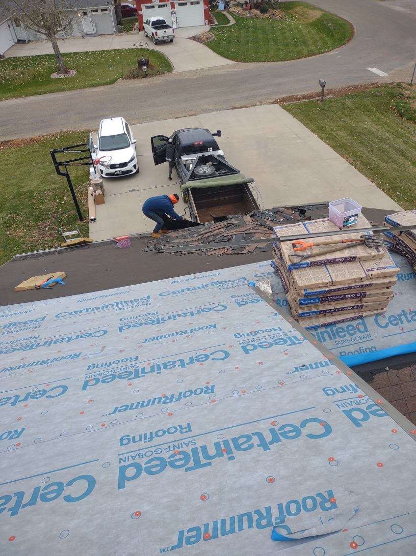 An aerial view of a roof being installed in a driveway.