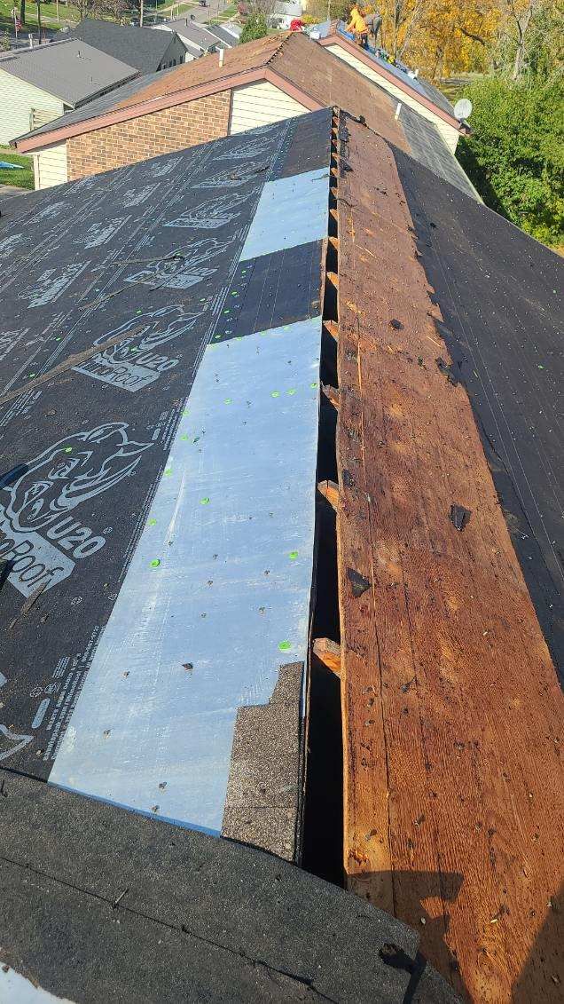 A close up of a roof with a gutter on it.
