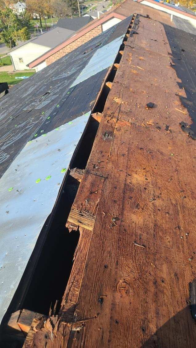 A close up of a rusty metal structure on top of a roof.