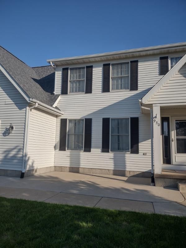A white house with black shutters on the windows