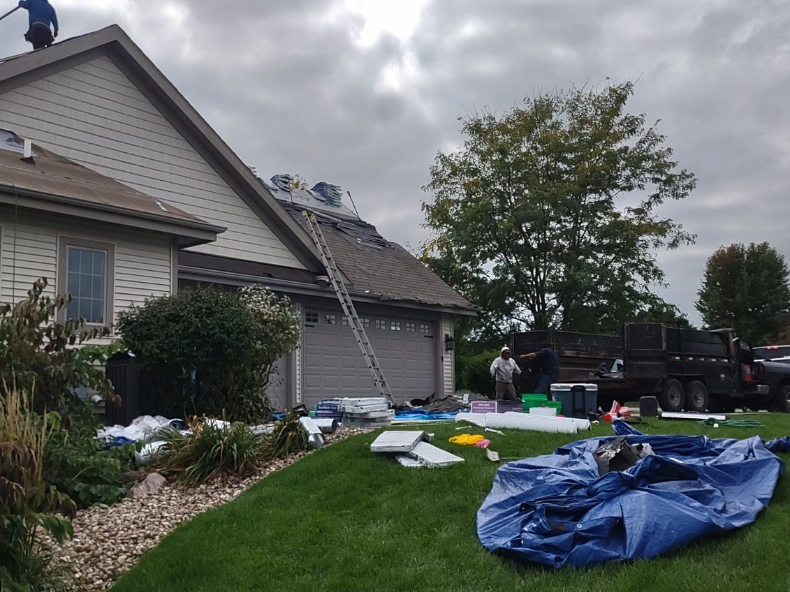 A man is working on the roof of a house.