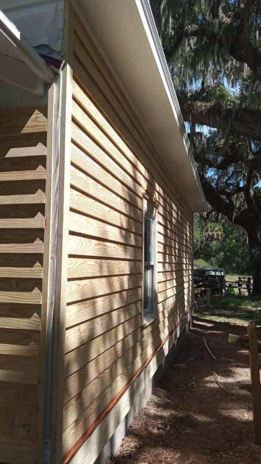 The side of a house with wooden siding and a window.