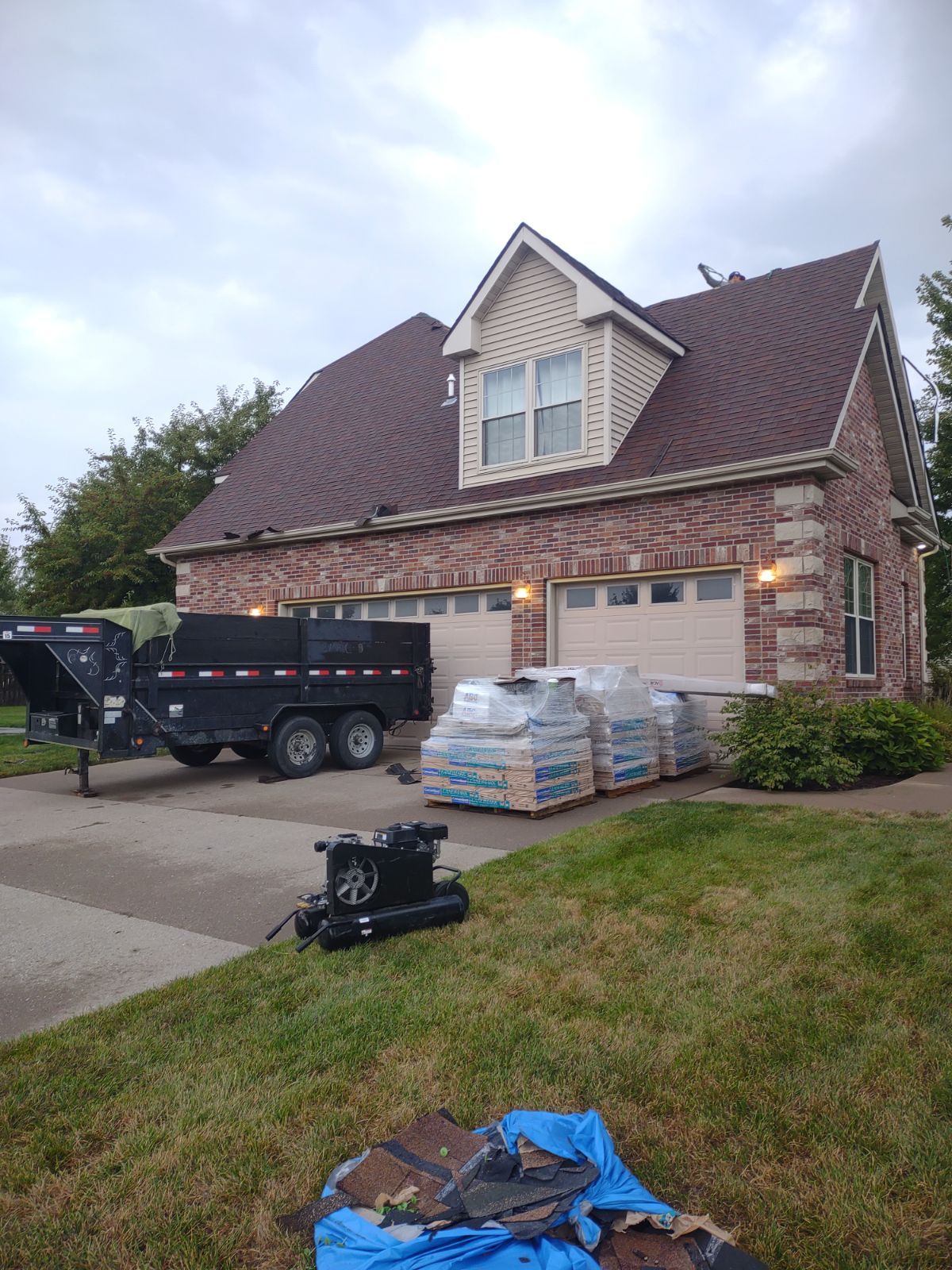 A house with a trailer parked in front of it.