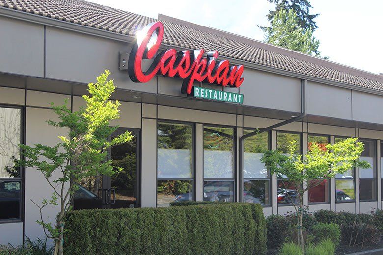 A large building with a sign that says caspian restaurant