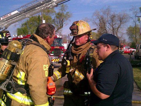A group of firefighters standing next to each other 