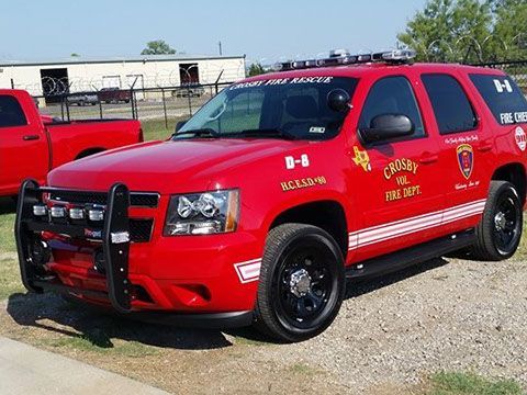 A red fire suv with the word Crosby vol. fire department on the side