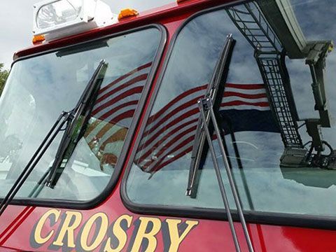 A red fire truck with the word Crosby on the front