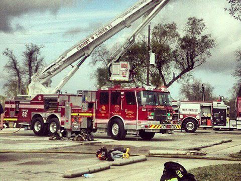 A red and white fire truck with a ladder on top of it