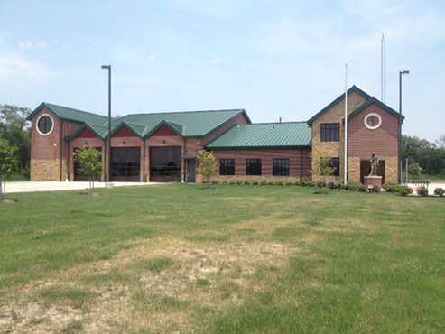 A picture of a Crosby VFD fire station with a green roof. 