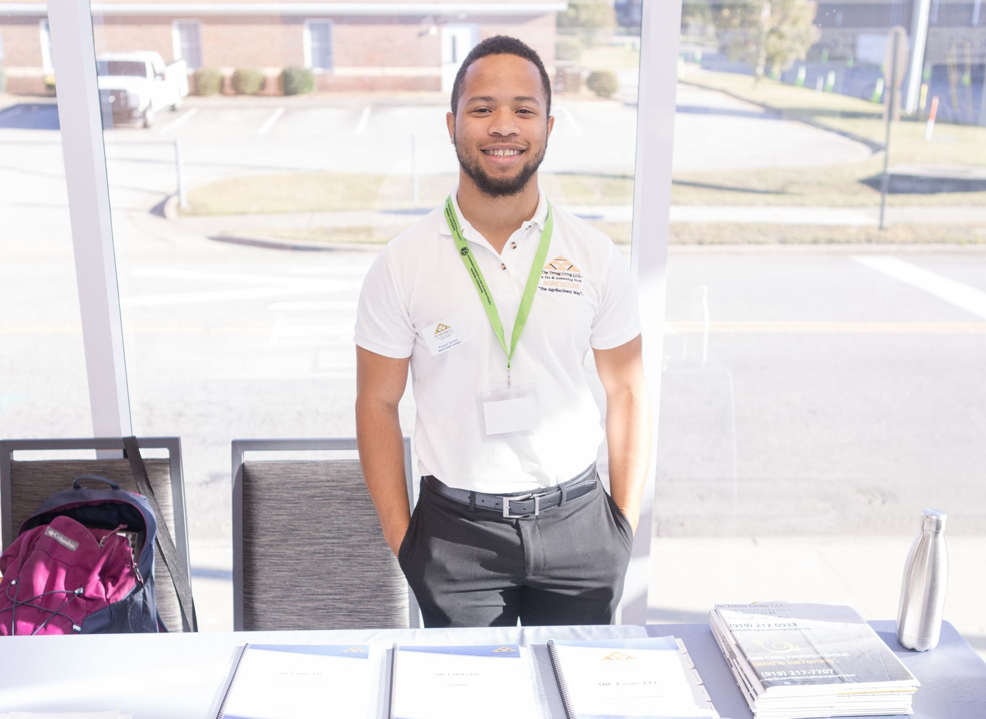 Mr. Darrell Tennie smiling and inspecting trees during a field visit with Tennie Agriculture Group.