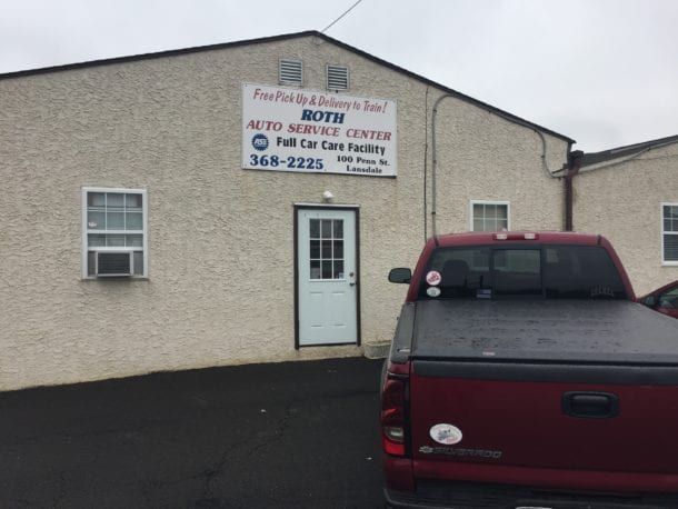 Roth Auto Service Center building with red truck parked out front.