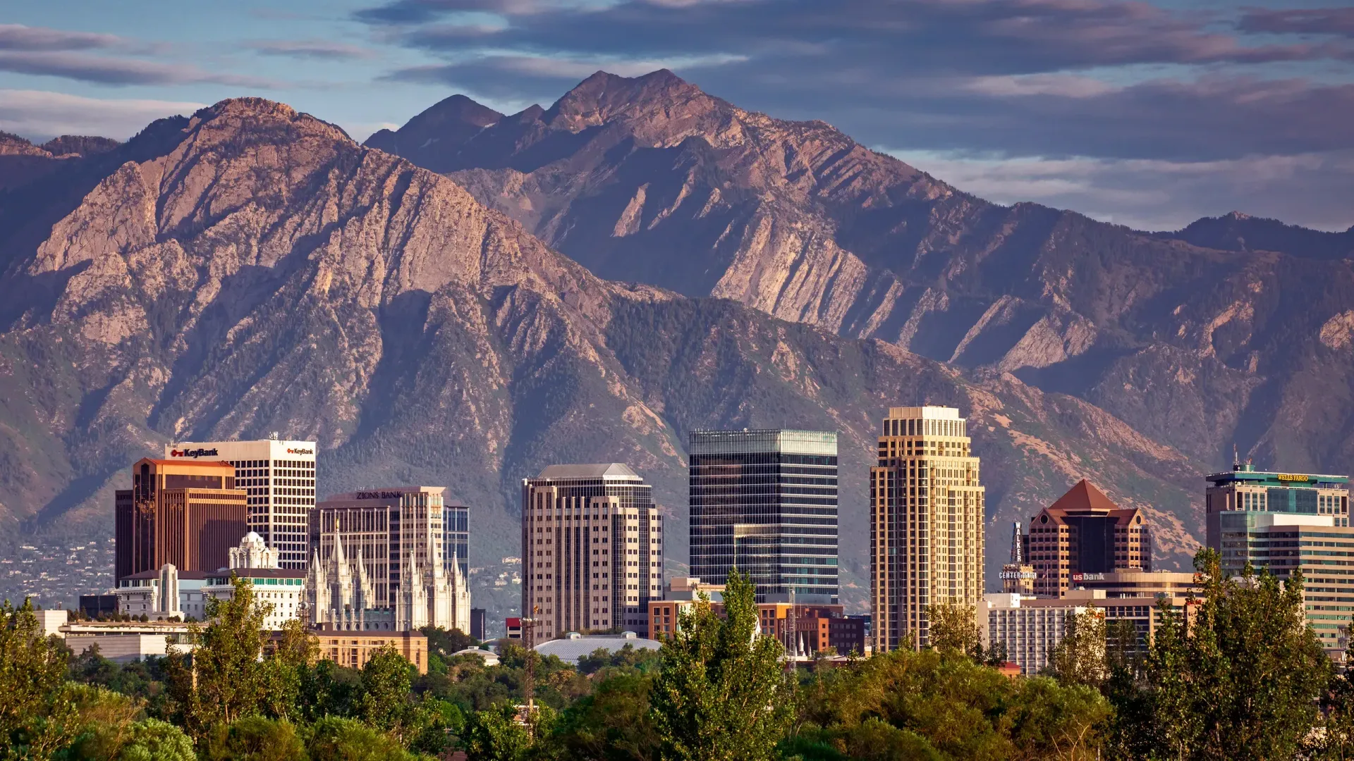 A city skyline with mountains in the background