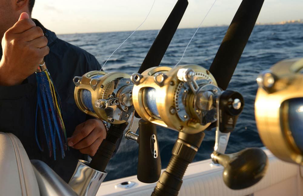 Man Holding Lure While Deep Sea Saltwater Fishing — Fishing Store in South West Rocks, NSW