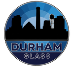A circular logo featuring a black silhouette of the Durham, North Carolina skyline against a blue sunburst, with text.