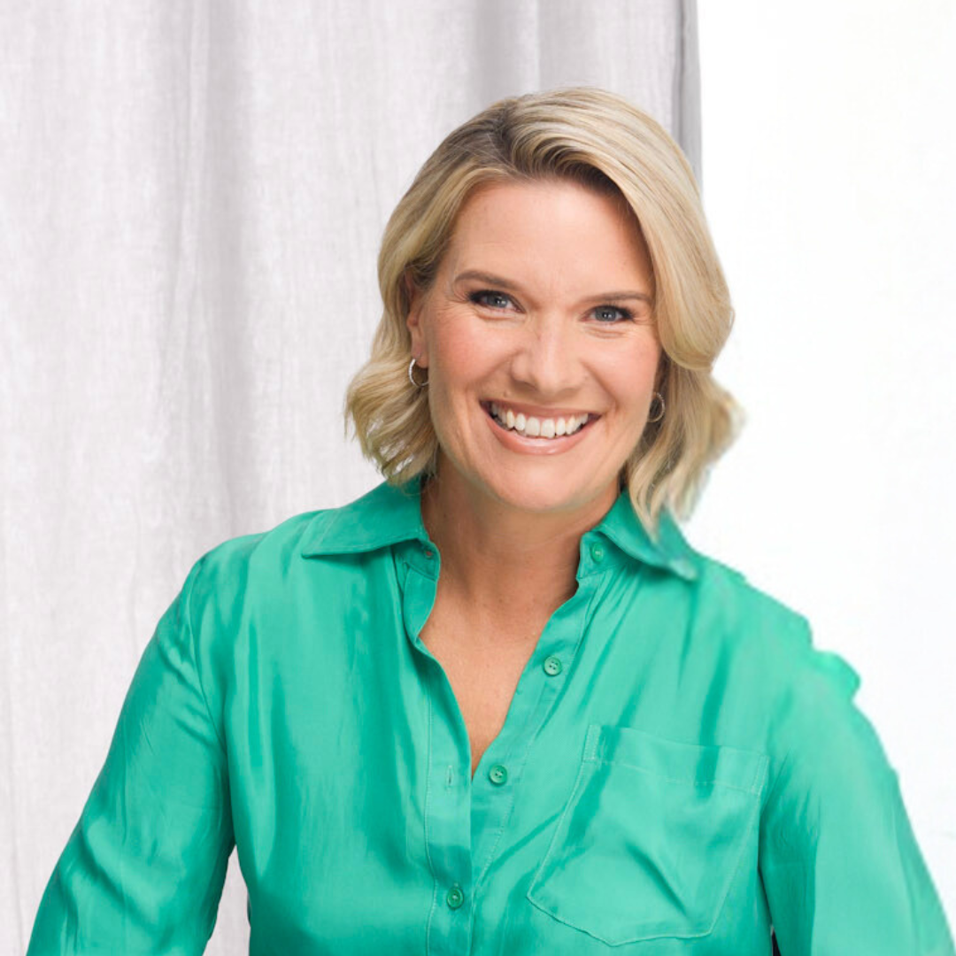A woman in a green shirt is smiling for the camera