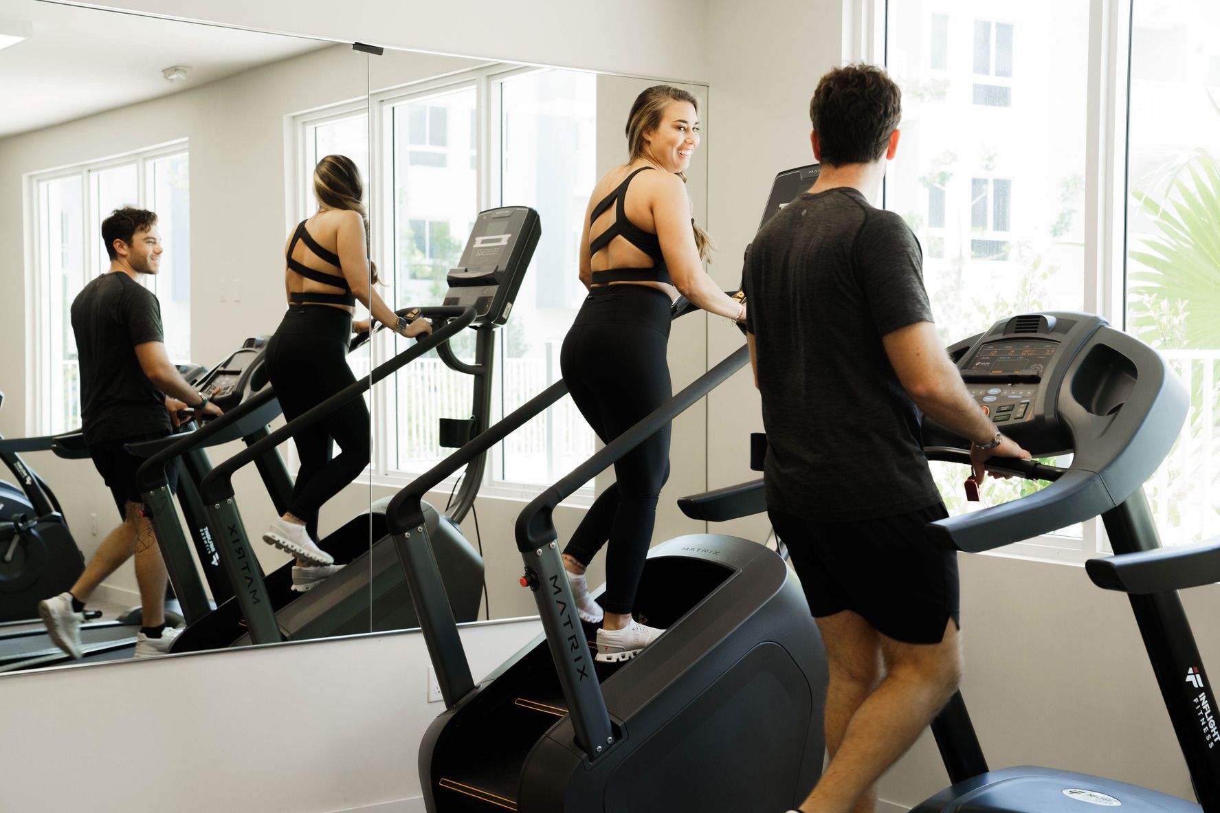 A group of people are using treadmills in a gym.