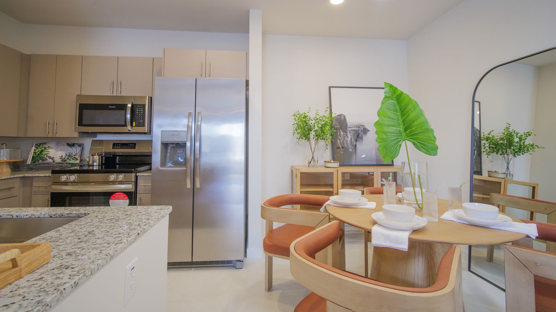 A kitchen and dining room in a house with a table and chairs.