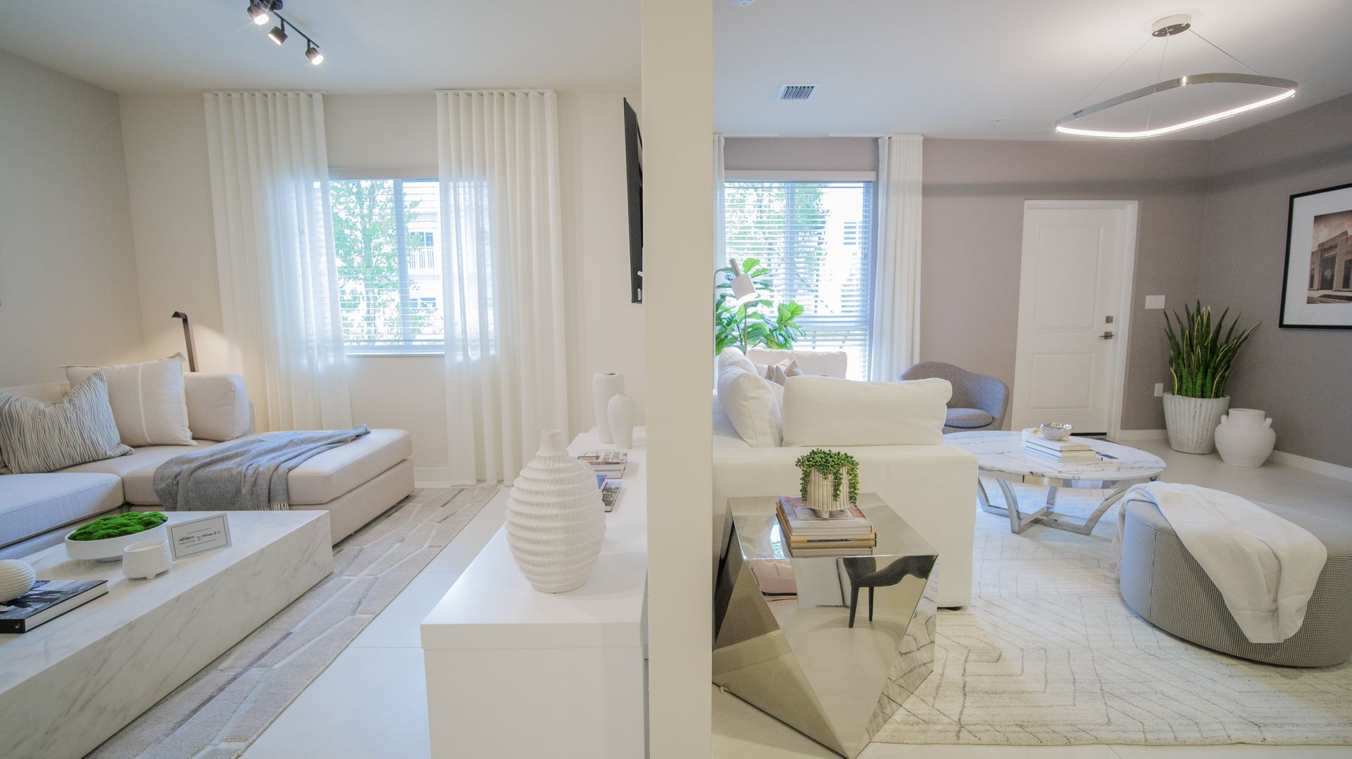 A living room with a couch , chairs , and a table.