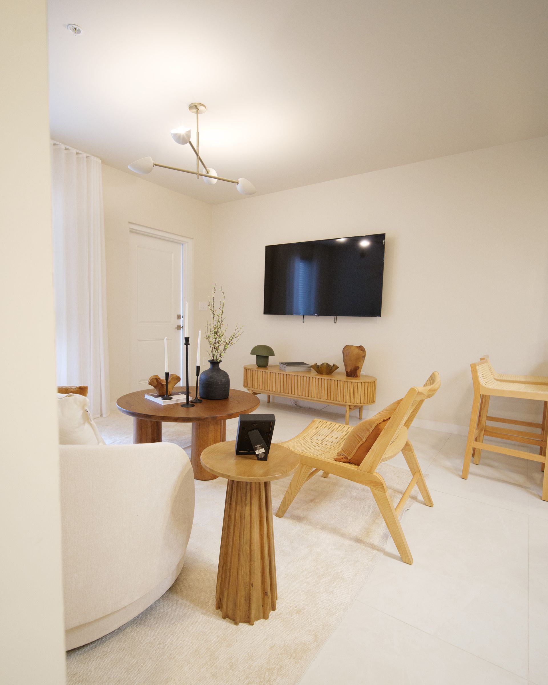A living room with a couch a chair a table and a flat screen tv