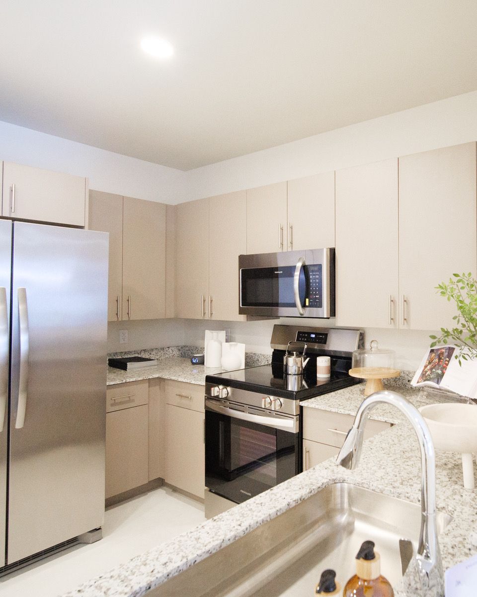 A kitchen with stainless steel appliances and granite counter tops