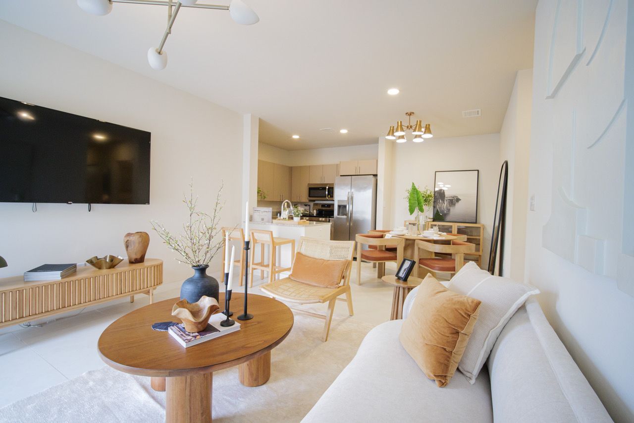 A living room with a couch , table , and television.