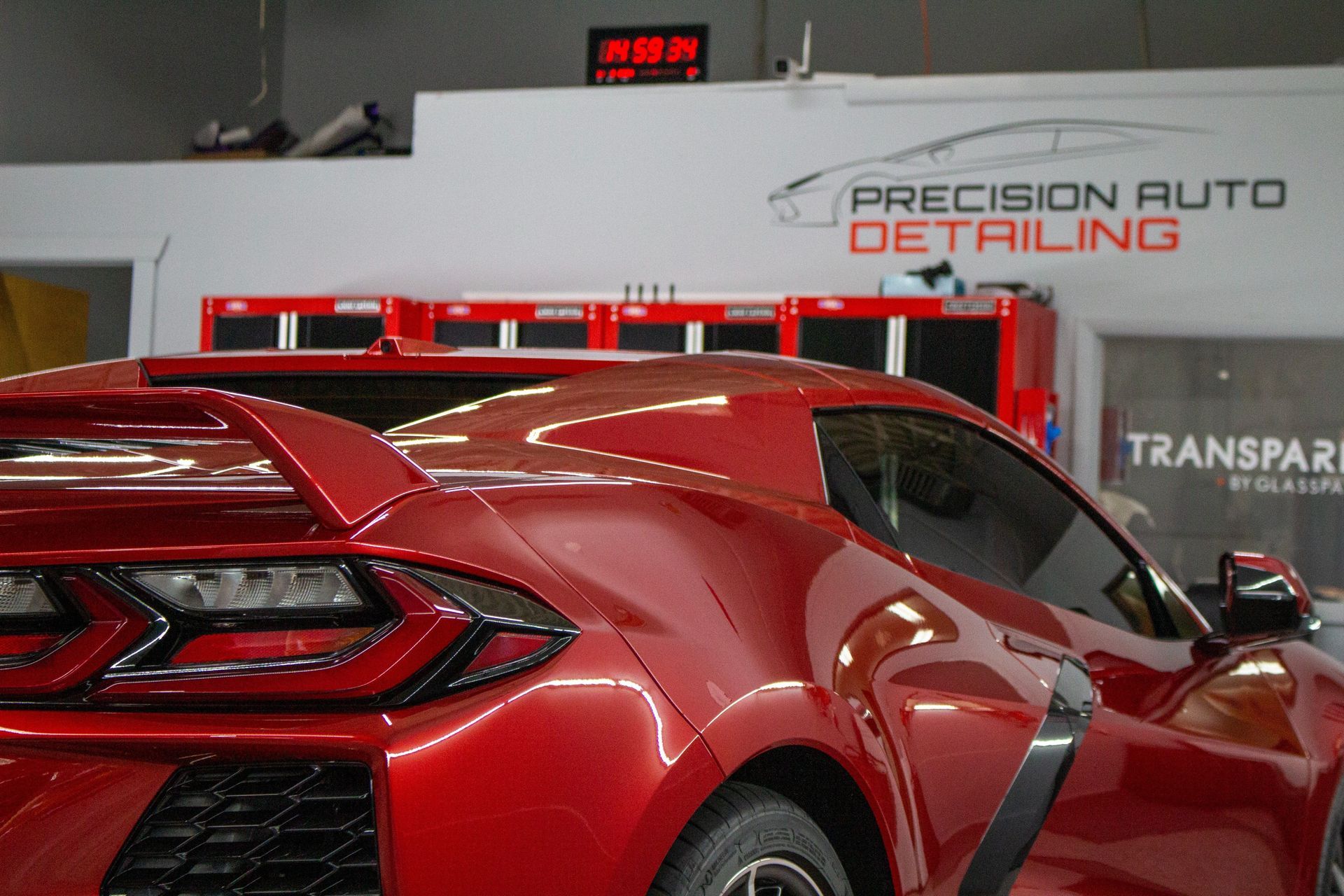 Red sports car at Precision Auto Detailing shop.