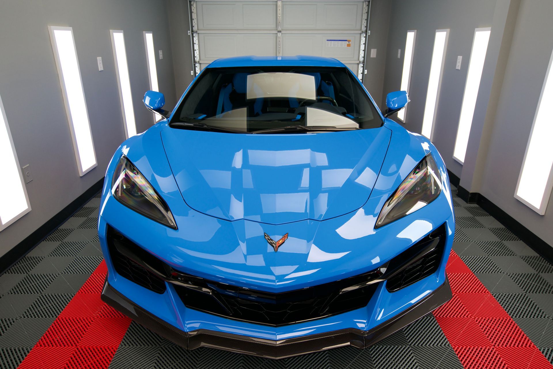 A blue sports car is parked in a garage.