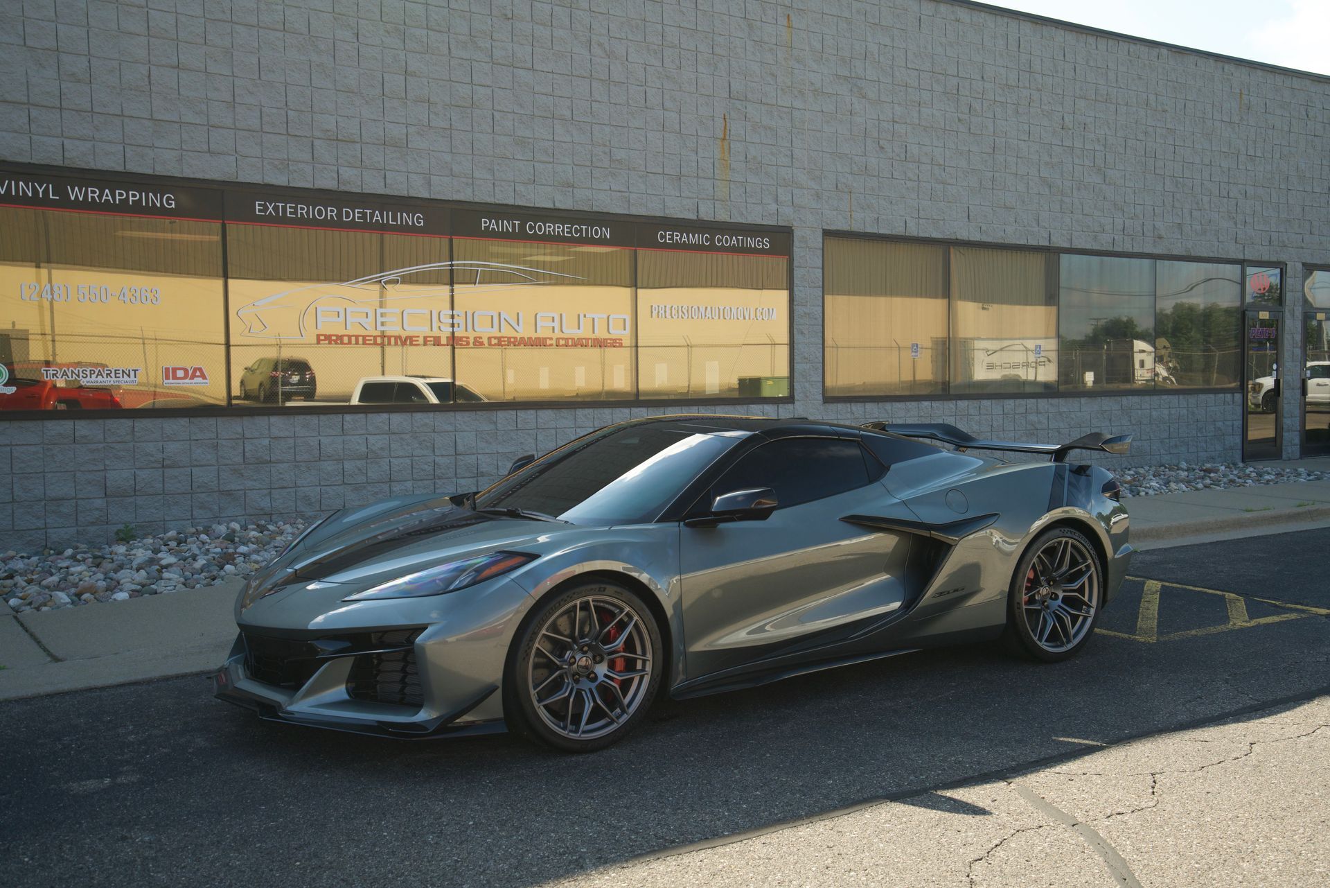 A red sports car is parked in a garage.