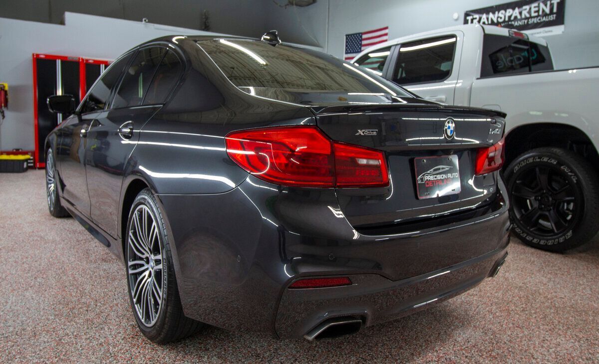 a black car is parked in a garage with window tinting