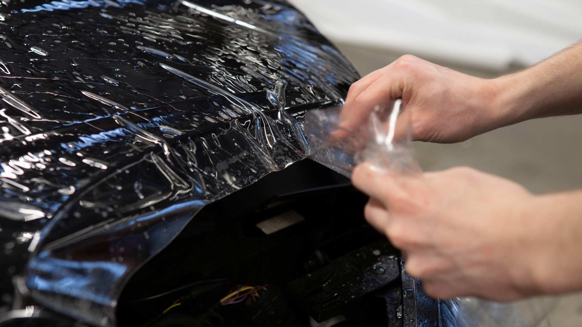Car hood with clear paint protection film applied to guard against chips, scratches & harsh elements