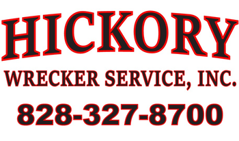 A red and black logo for hickory wrecker service inc.