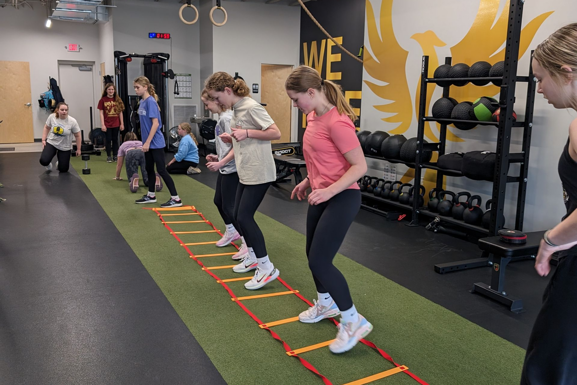 Person holding a mug, next to a bowl of cereal and a magazine on a wooden table.
