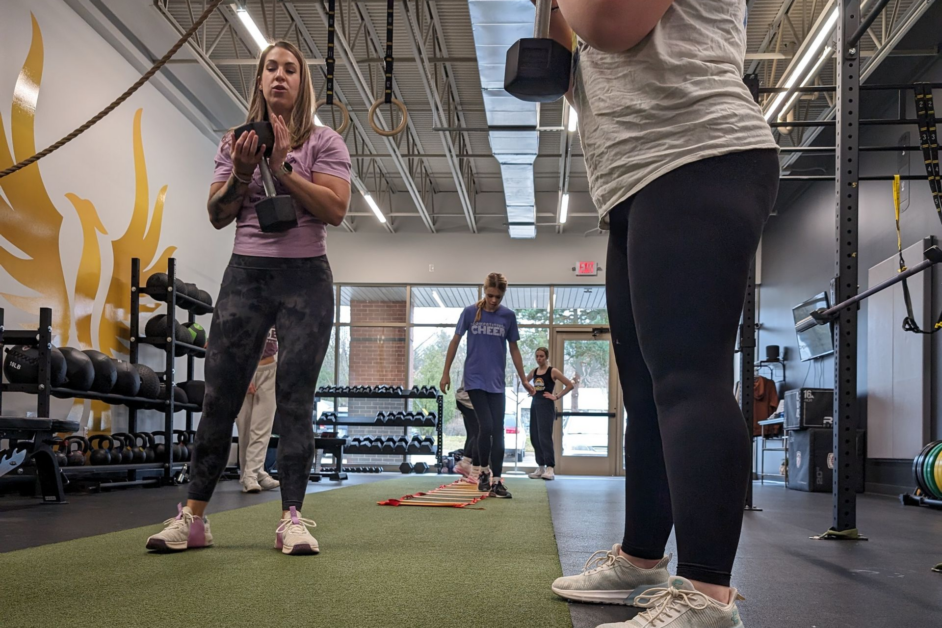 Person holding a mug, next to a bowl of cereal and a magazine on a wooden table.