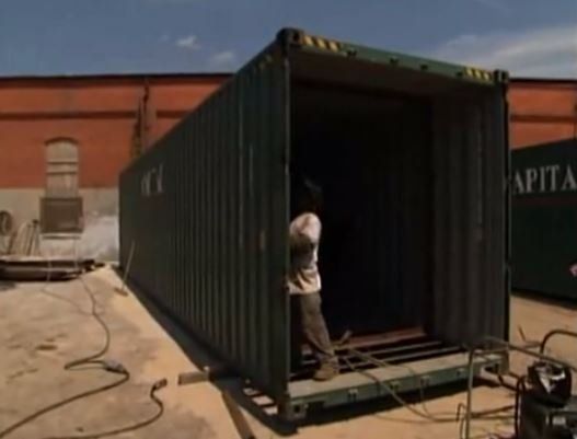 Cutting out sections in a shipping container with a plasma torch 
