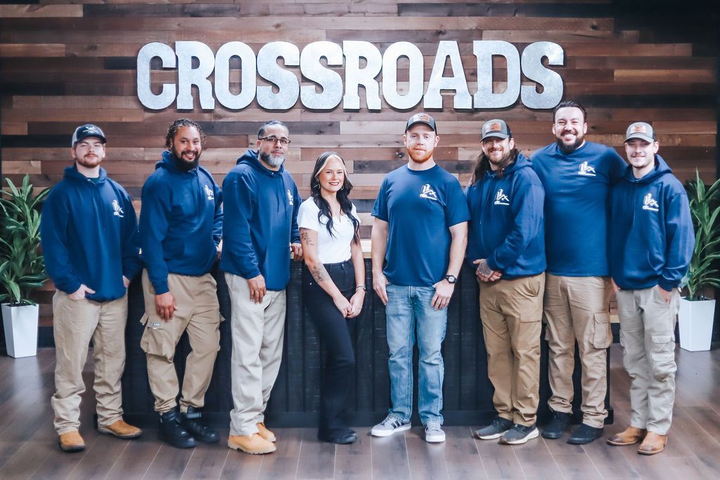 Modern living room with blue accent wall, built-in shelves, and a dark blue sofa.