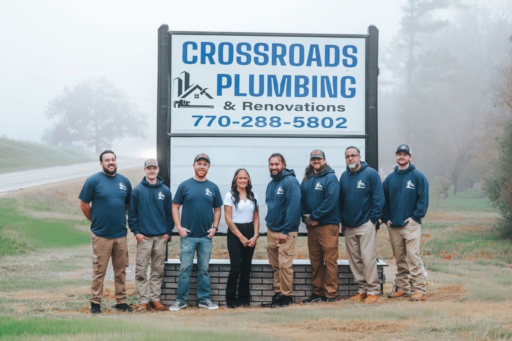 Curved hallway with red chairs, floor-to-ceiling windows with blinds, and white columns.