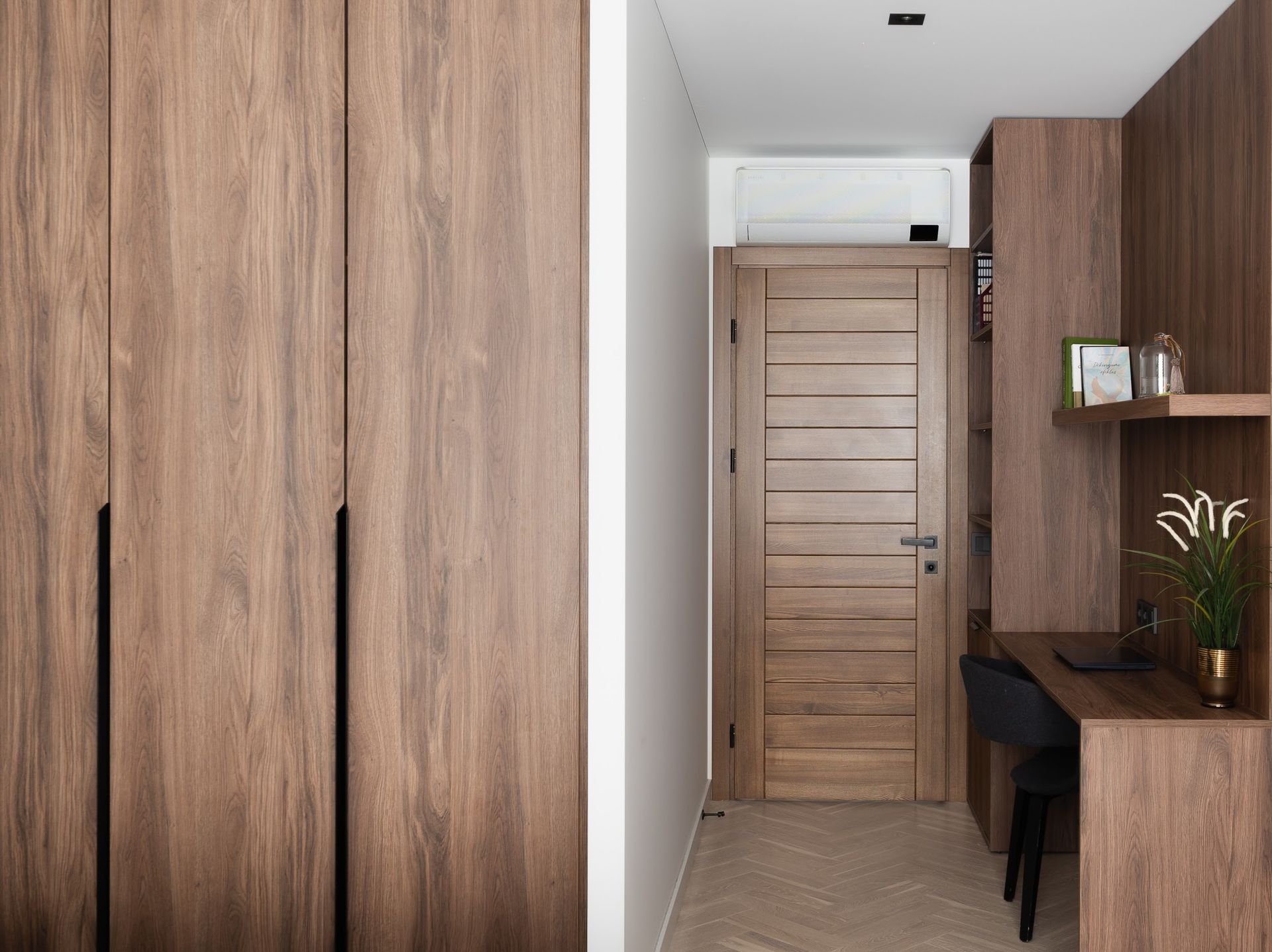 Koridorius su medinėmis durimis ir mediniu stalu.